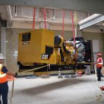 Generator installed for Verizon being hoisted to the rooftop