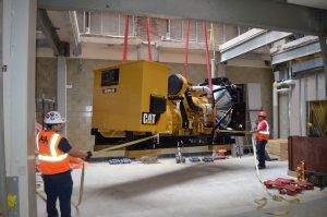 Generator installed for Verizon being hoisted to the rooftop